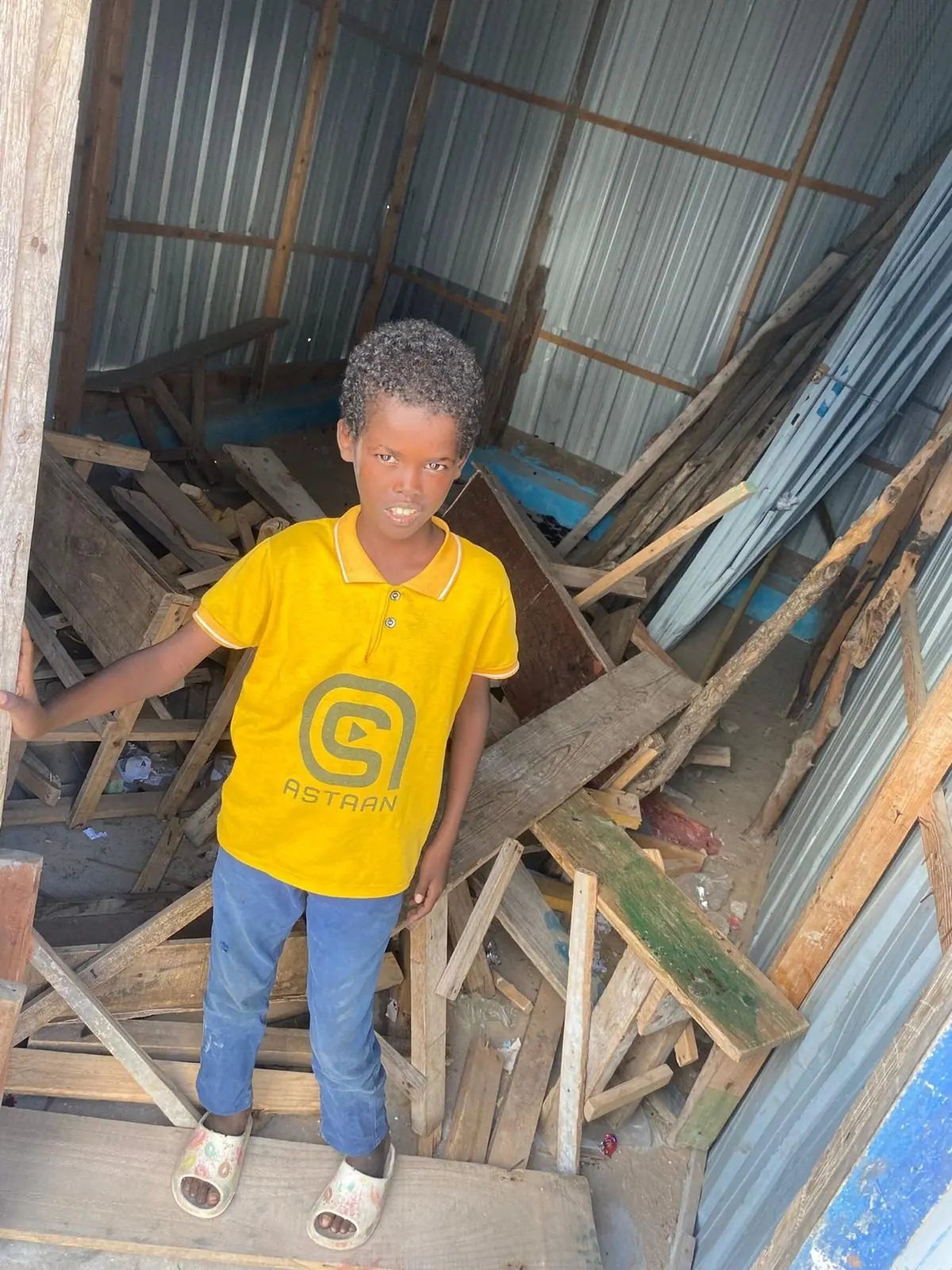 A boy outside his family's shelter in Mogadishu