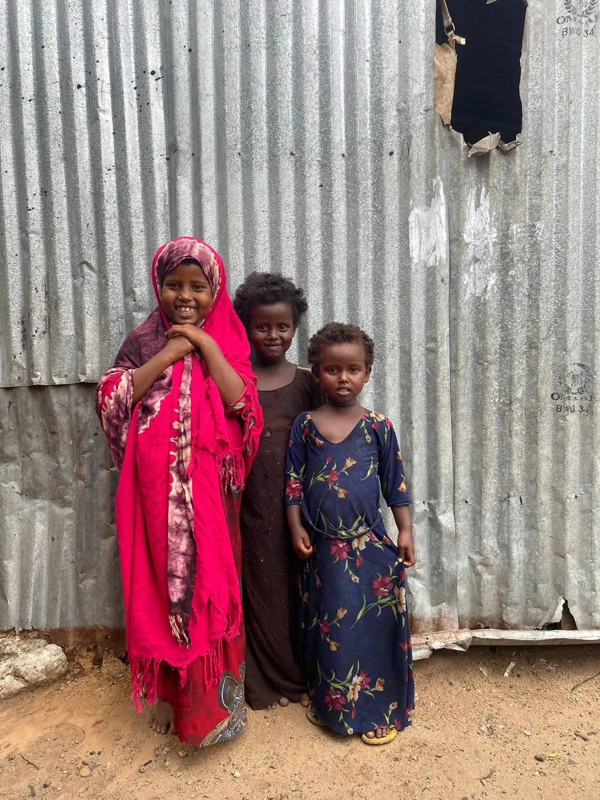 Three girls outside their home in Mogadishu